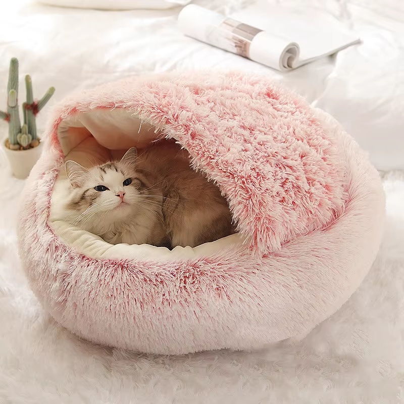 Cat resting in the pink hooded bed