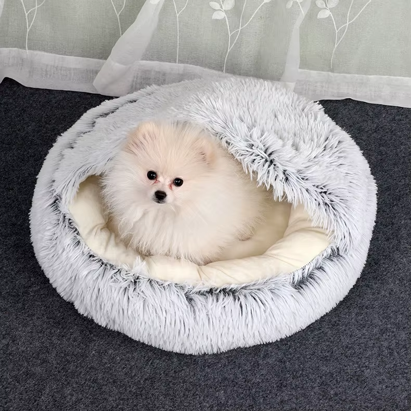 Small dog in the grey plush bed