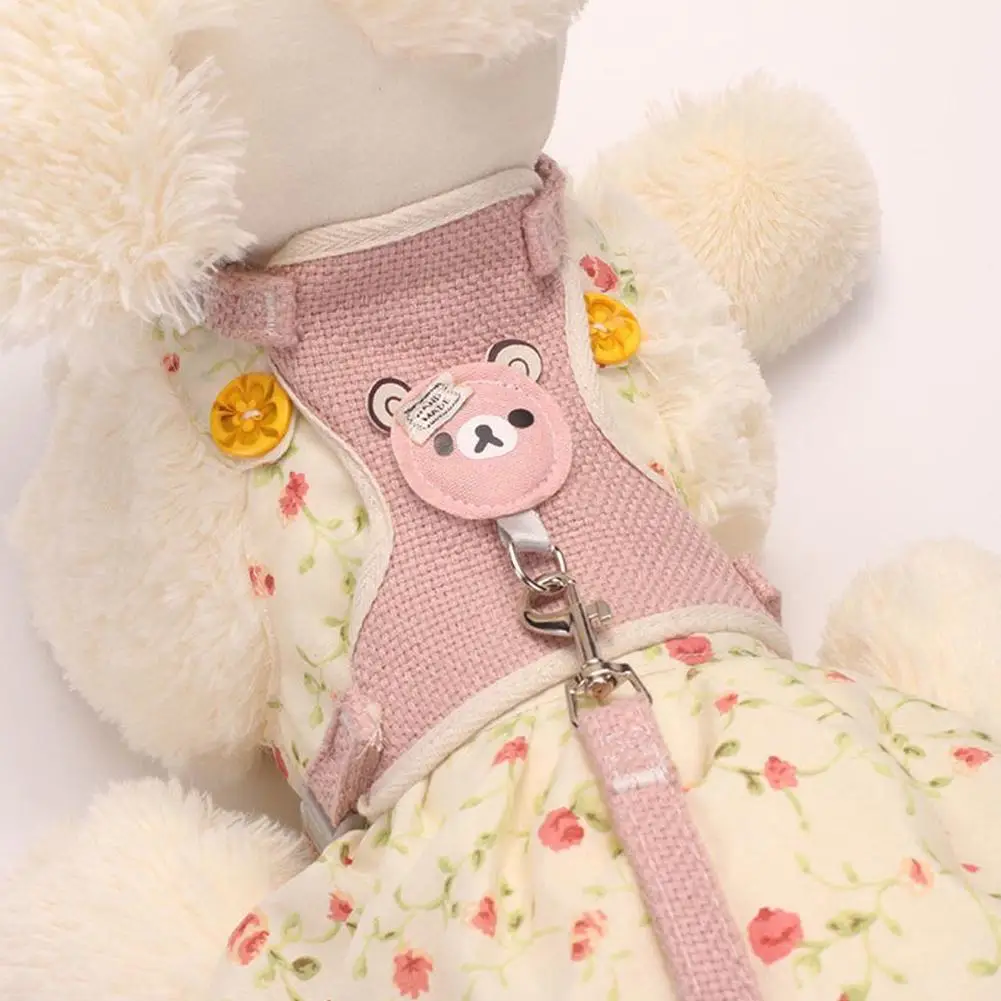 Small dog wearing the pink bear-patch harness