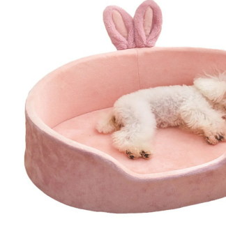 Pink bunny-ear pet bed with small dog resting inside